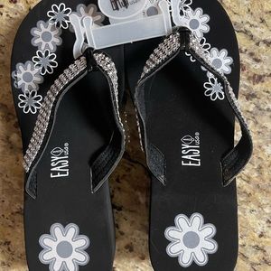 Flip flops with flowers on them. 2” heel.  Never worn.  New without tag